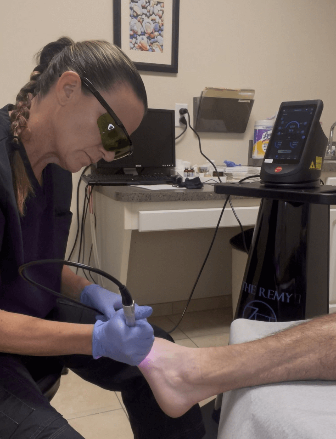 Podiatrist Dr. Michele McGowan Performing Laser for Tendon Pain